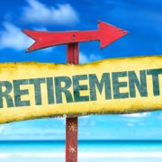 An Image of a Sign on a Beach Pointing to Retirement Put On By Secure Money Advisors In Pittsburgh