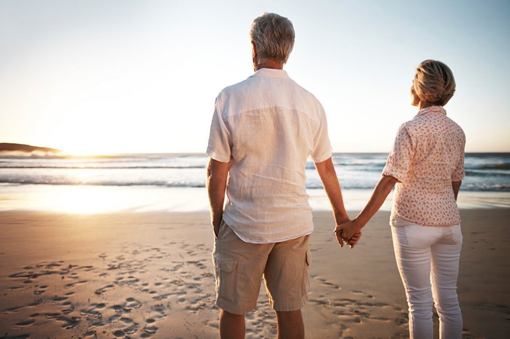 An Image of a Retired Couple Holding Hands On The Beach Put On By Secure Money Advisors In Pittsburgh