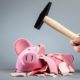 An Image of a Hammer With a Smashed Pink Piggy Bank Put On By Secure Money Advisors In Pittsburgh