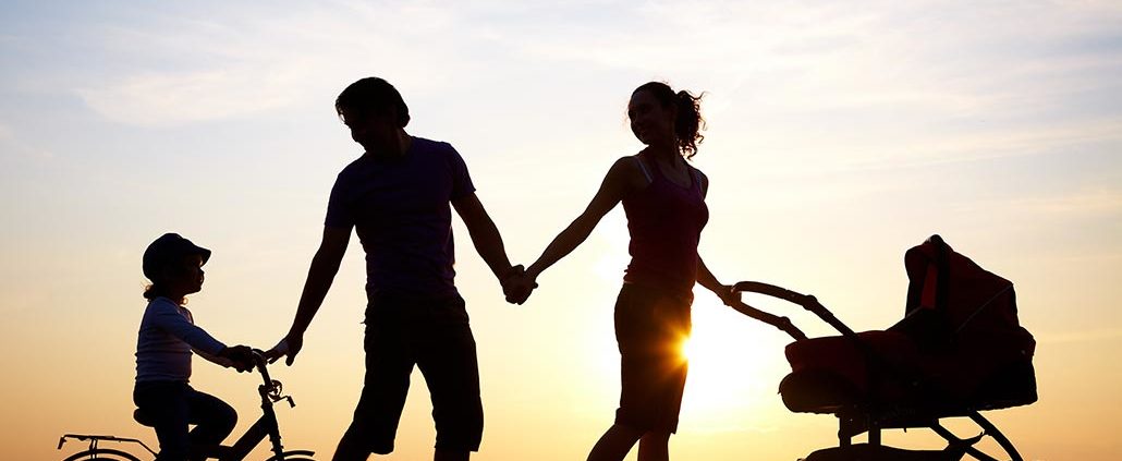 An Image of a Family Holding Hands and Walking During Sunset Put On By Secure Money Advisors In Pittsburgh