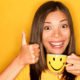 An Image of a Women Smiling with Her Thumbs Up While Holding a Small Cup Put On By Secure Money Advisors In Pittsburgh