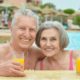 An Image of a Retired Couple in a Pool Drinking a Beverage Put On By Secure Money Advisors In Pittsburgh