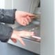 An Image of Someone Depositing Cash Into an ATM Put On By Secure Money Advisors In Pittsburgh