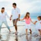 An Image Of A Couple And Two Kids Holding Hands While Walking On The Beach To Represent Saving For Retirement Early Put On By Secure Money Advisors In Pittsburgh