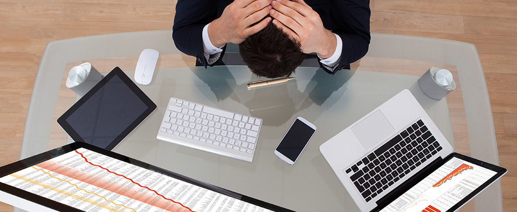 An Image Of A Man With His Head Down After Looking At His Investments On His Computer Put On By Secure Money Advisors In Pittsburgh