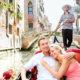 An Image Of A Young Couple Riding A Small Boat Along The Rive In Italy Experiencing Financial Freedom And Enjoying Life Put On By Secure Money Advisors In Pittsburgh