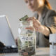 An Image Of A Women Putting Money Into A Jar That Is Marked As 401K To Represent How to Max Out Your 401(k) Put On By Secure Money Advisors In Pittsburgh