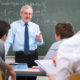 An Image Of An Older Man Teaching Math In A Classroom As The Most Enjoyable Jobs For Older Workers Put On By Secure Money Advisors In Pittsburgh