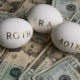 An Image Of Three Eggs With The Words Roth, IRA, And 401K Written In Gold Laid On Top Of 20 Dollar Bills Put On By Secure Money Advisors In Pittsburgh