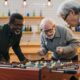 An Image Of Retired People Playing Foosball And Sharing the Secrets of Early Retirement Put On By Secure Money Advisors In Pittsburgh
