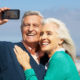 An Image Of A Couple Taking A Picture Of Themselves On Their Phone Enjoying Their Retirement Put On By Secure Money Advisors In Pittsburgh