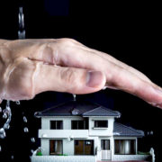 An Image Of A Hand Shielding A House From Water Put On By Secure Money Advisors In Pittsburgh