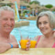 An Image Of A Couple Drinking A Beverage In The Pool Enjoying Retirement Put On By Secure Money Advisors In Pittsburgh