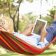 An Image Of A Man Reading An eBook In A Hammock Enjoying Retirement Put On By Secure Money Advisors In Pittsburgh