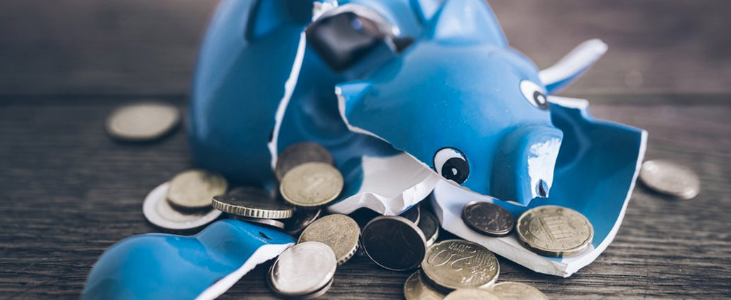 An Image Of A Broken Piggy Bank And Coins Scattered To Show Consequences Of An Early 401(k) Withdrawal Put On By Secure Money Advisors In Pittsburgh