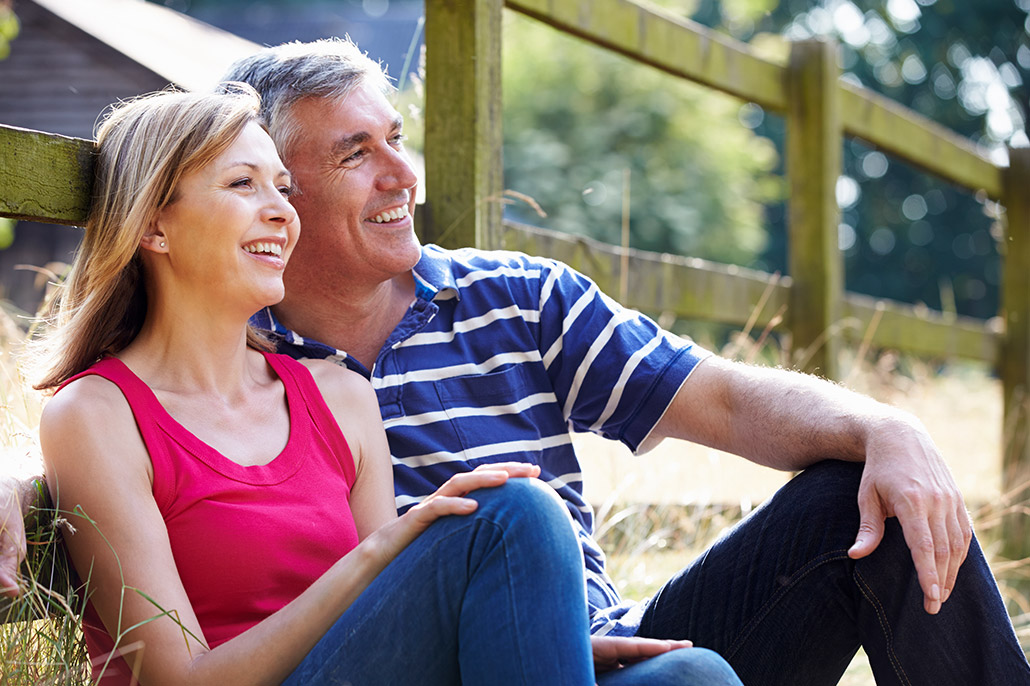 An Image Of A Couple Sitting In The Grass Looking For Financial Advisors Put On By Secure Money Advisors In Pittsburgh