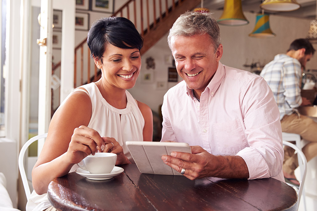 An Image Of A Couple At A Coffee Shop Looking At A Tablet For Best Fixed Annuities Plan Put On By Secure Money Advisors In Pittsburgh