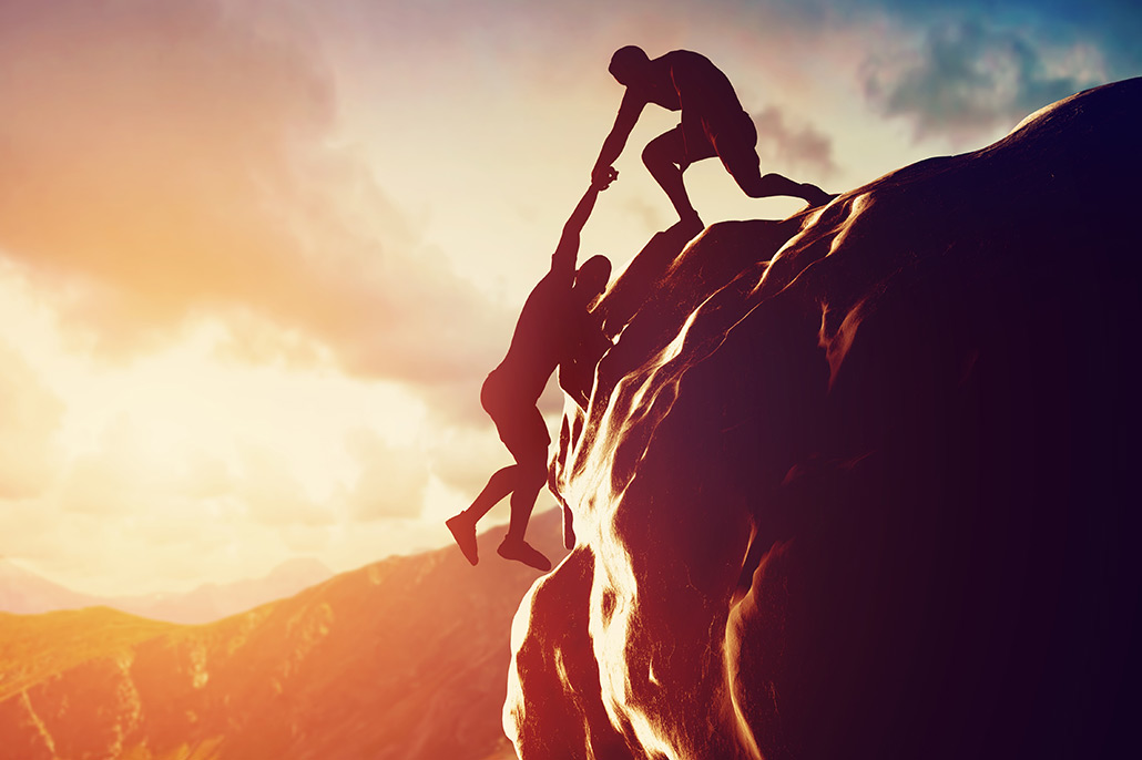 An Image Of A Person Lifting Another Up On A Cliff Put On By Secure Money Advisors In Pittsburgh